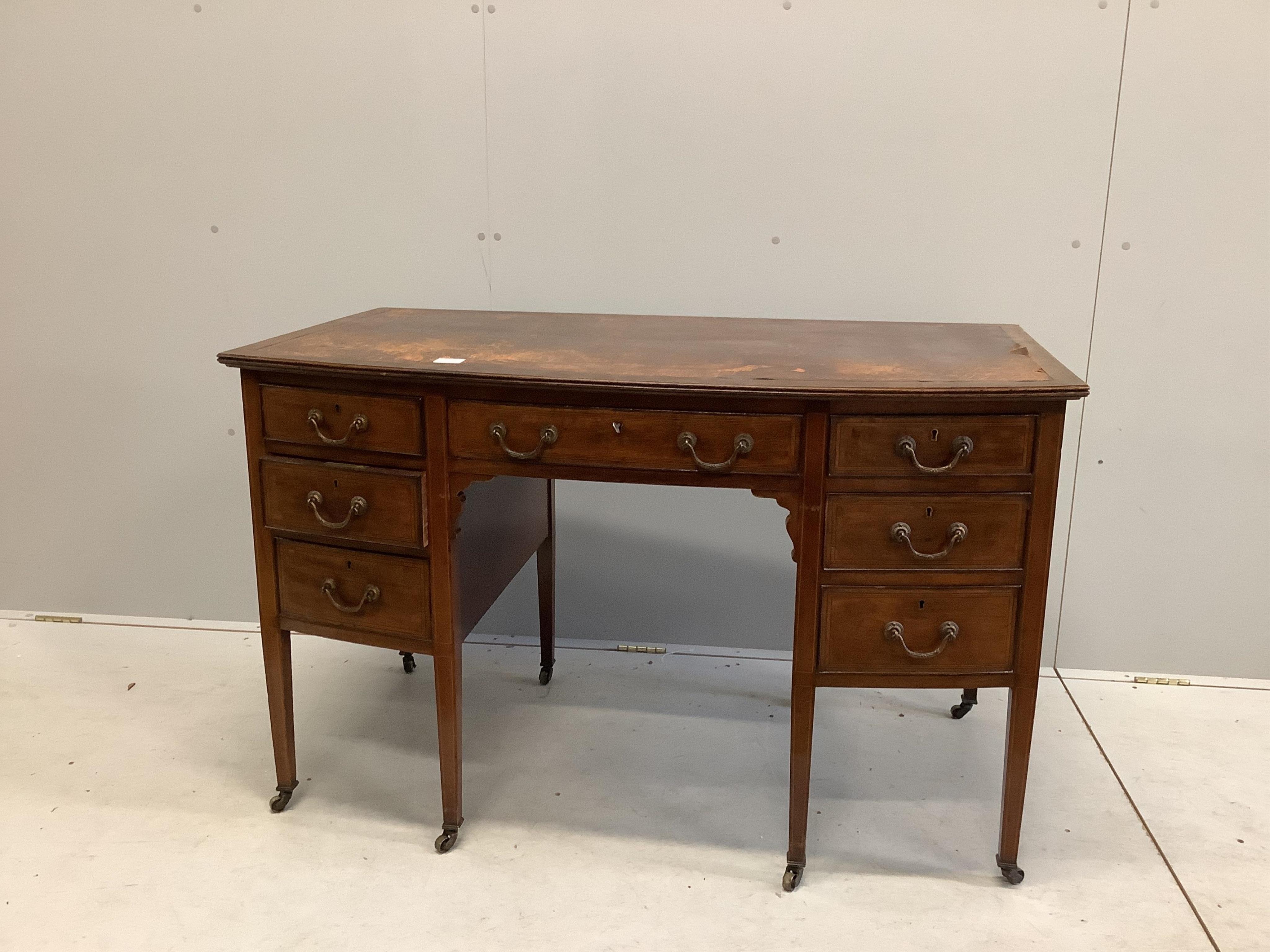 An Edwardian mahogany bowfront kneehole writing table, width 122cm, depth 70cm, height 76cm. Condition - fair